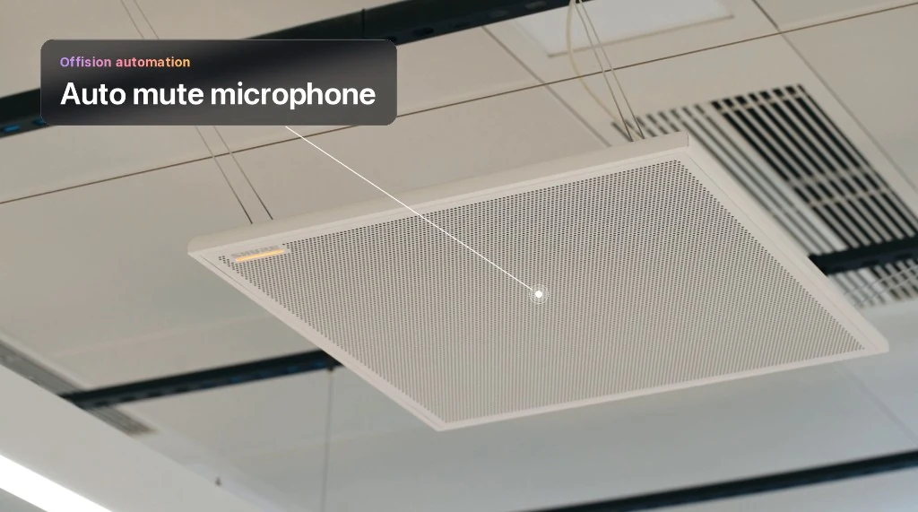 White perforated ceiling microphone panel suspended in a meeting room