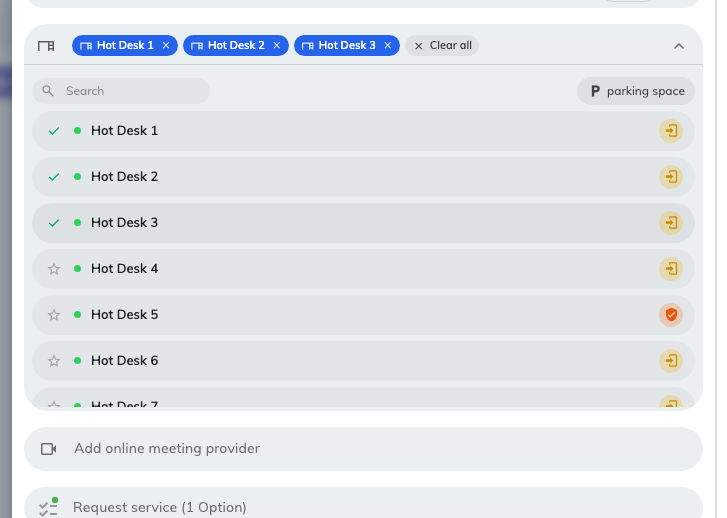 Three desks on one booking, each a chip with its own x — and a ticked row in the list below.